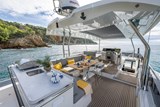 Flybridge with grill, seating, sun pad and T-top with electric opening.
